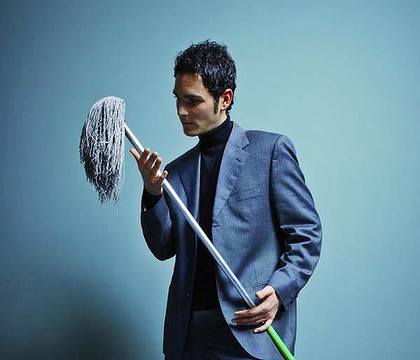 PatheticHousework2 bizarre image of a very dapper young man in beautiful suit holding a mop and looking poetically sad, oh how low he has sunk