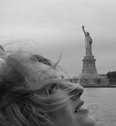 promo pic black and white in front of the statue of Liberty