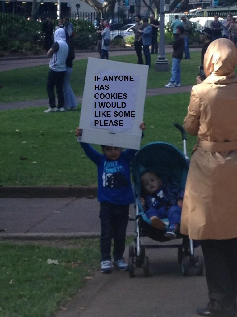 A spoofed image of the kid with the "beheading" sign at the Sydney Muslim protest - instead of the original message he has a sign saying "If anyone has any Cookies i would like some please"